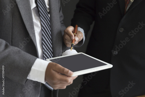 businessman in suit discuss and analyze with tablet