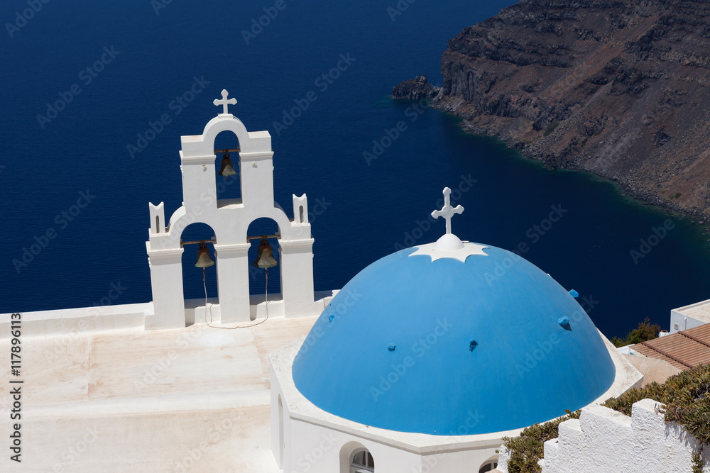 The Three bells of Fira and blue dome, Santorini, Greece.