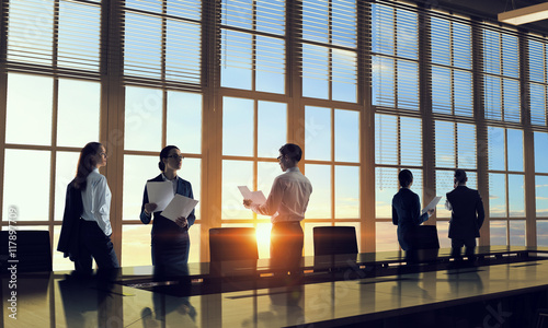 Silhouettes of Business People in Office. Mixed media . Mixed media