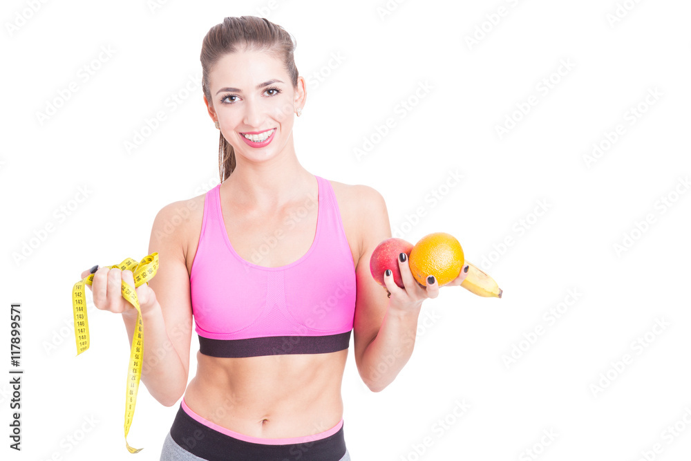 Female at gym holding tape line and fruits Female at gym holding tape line and fruits