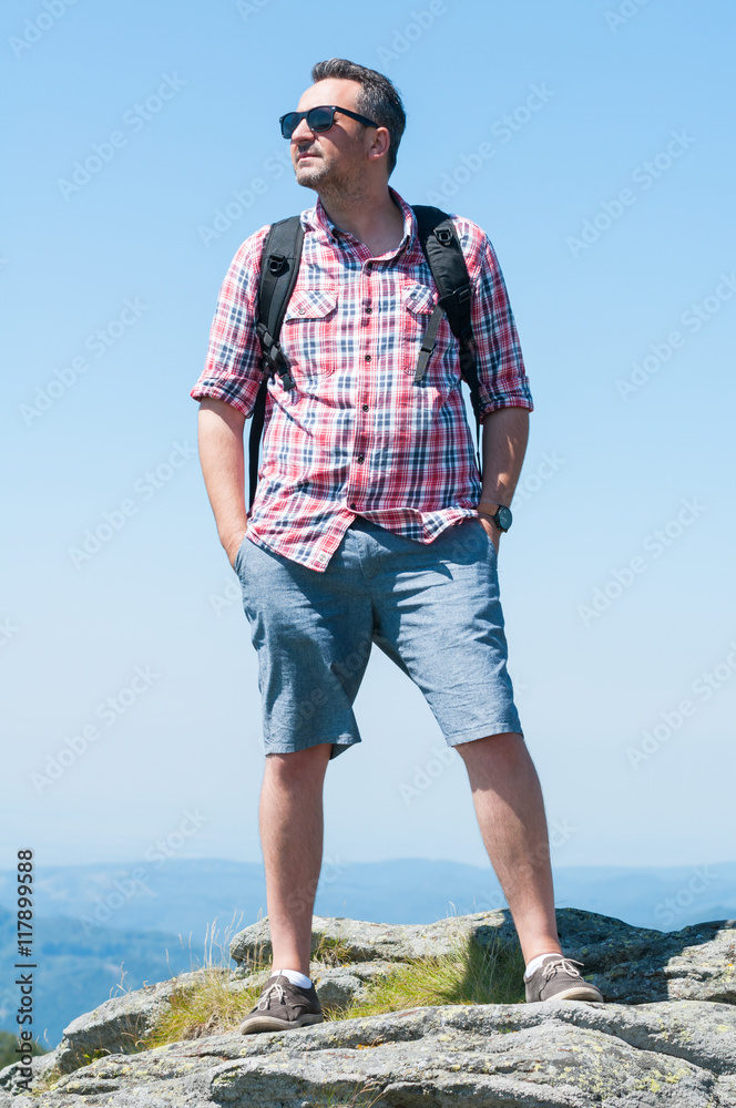 Man on top of the mountain looking away