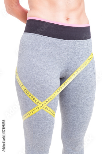 Fit woman standing with tape line around leg