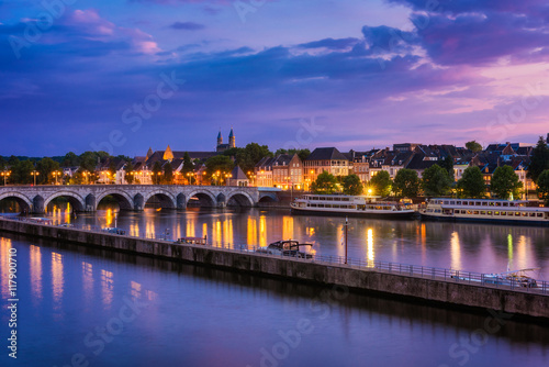 Maastricht Netherlands with 13th Century Sint Servaas bridge and Maas River around sunset photo