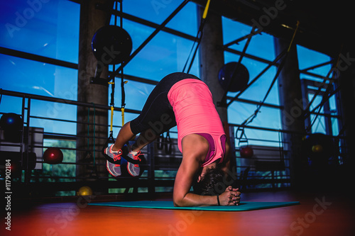 workout training fitness young girl women in a gym with strong lights on a carpet