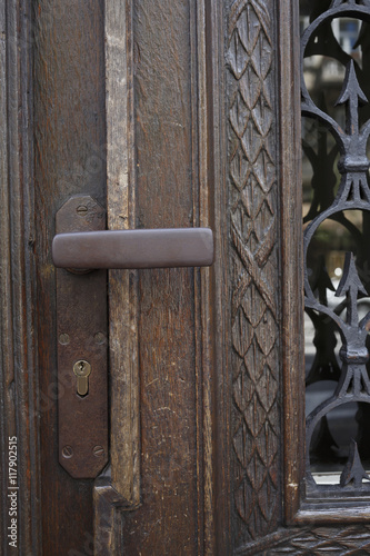 Rustic wooden door with iron handle.