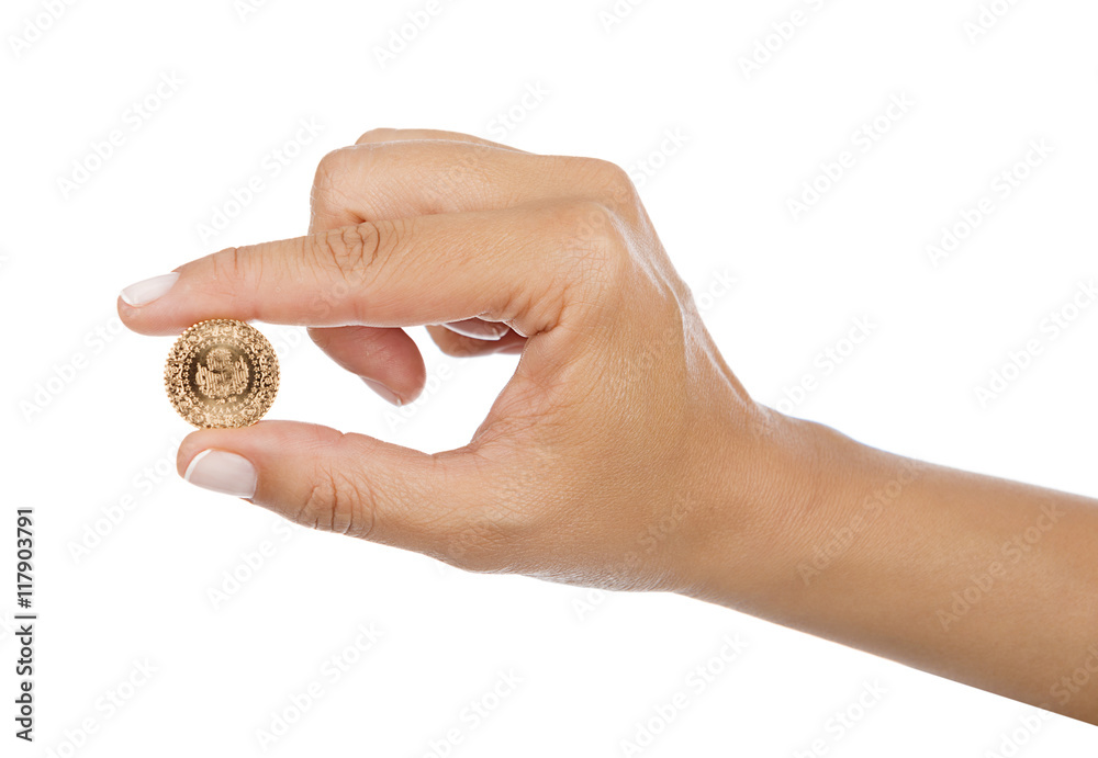 Turkish gold coin in between female fingers isolated Turkish gold coin in between female fingers isolated