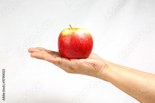 Red apple held on hand