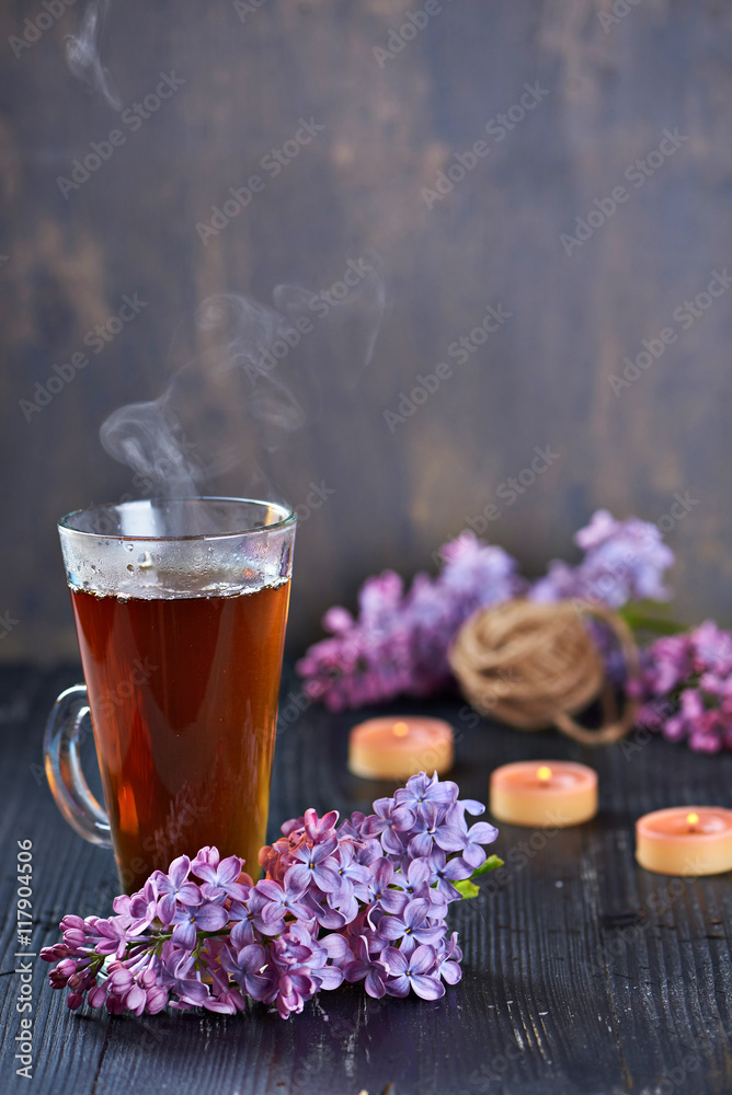 Pouring Healthy Tea with candles on a bakcground Pouring Healthy Tea with candles on a bakcground