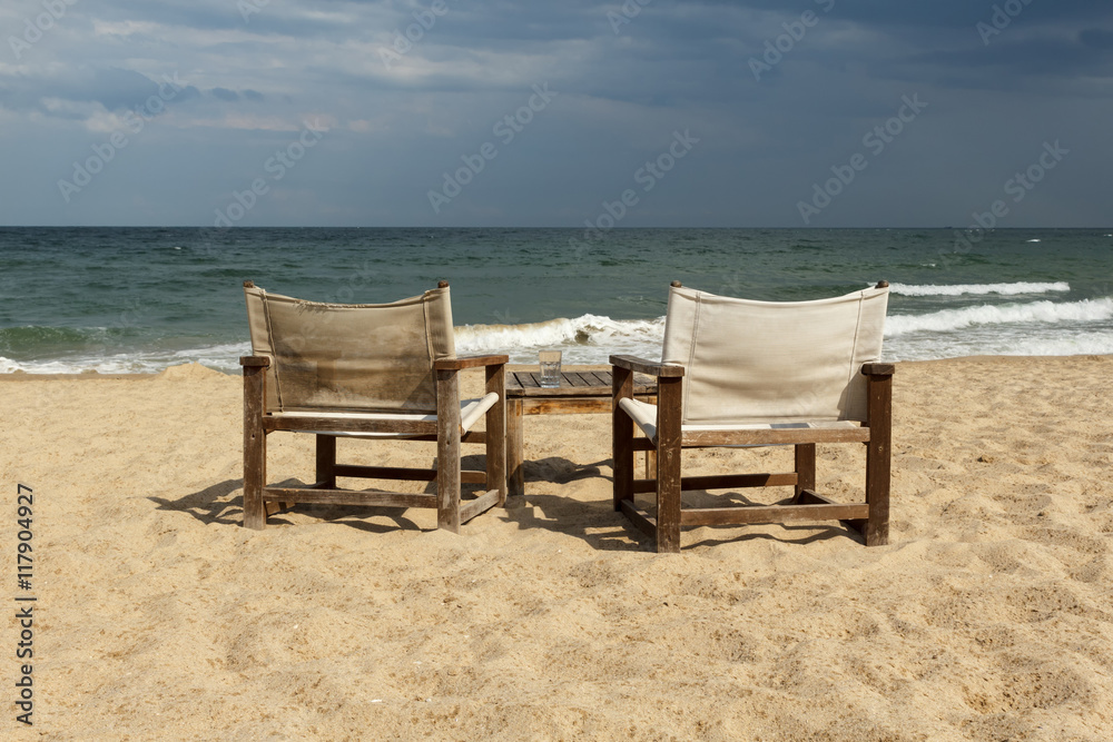 Seaside view with two chairs and table