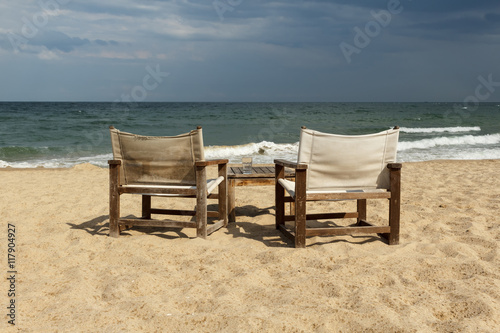 Seaside view with two chairs and table