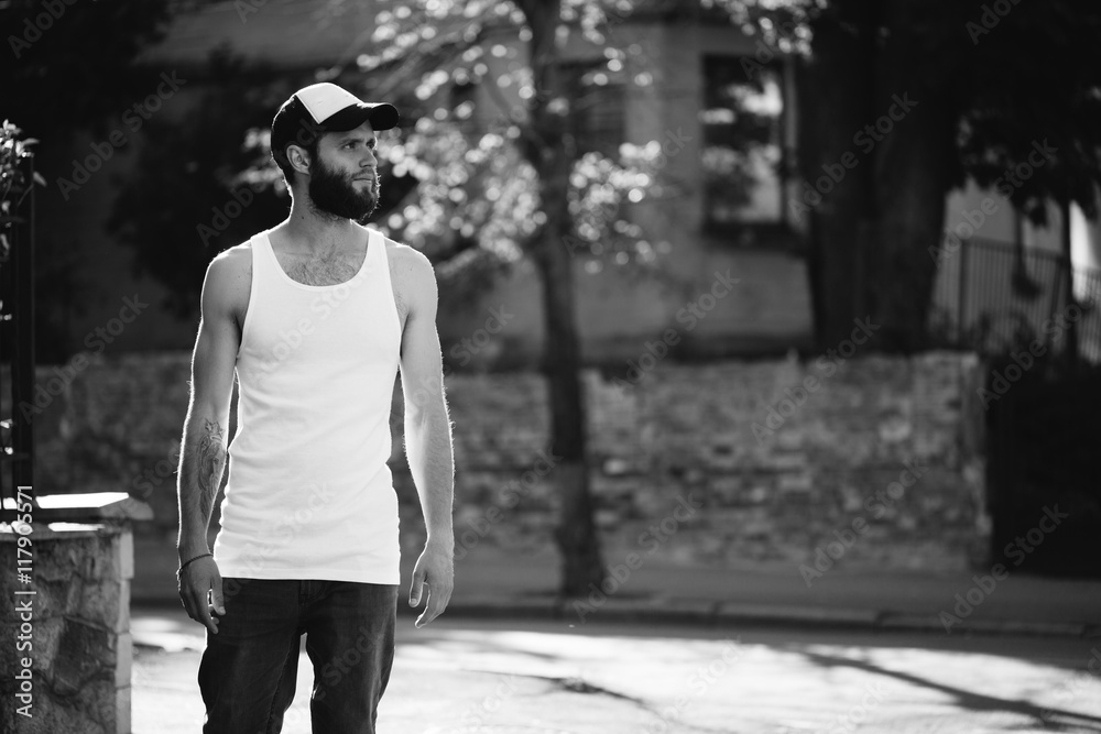hipster wearing white blank t-shirt and a baseball cap hipster wearing white blank t-shirt and a baseball cap