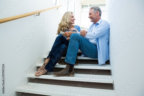 Smiling couple sitting on steps © WavebreakMediaMicro