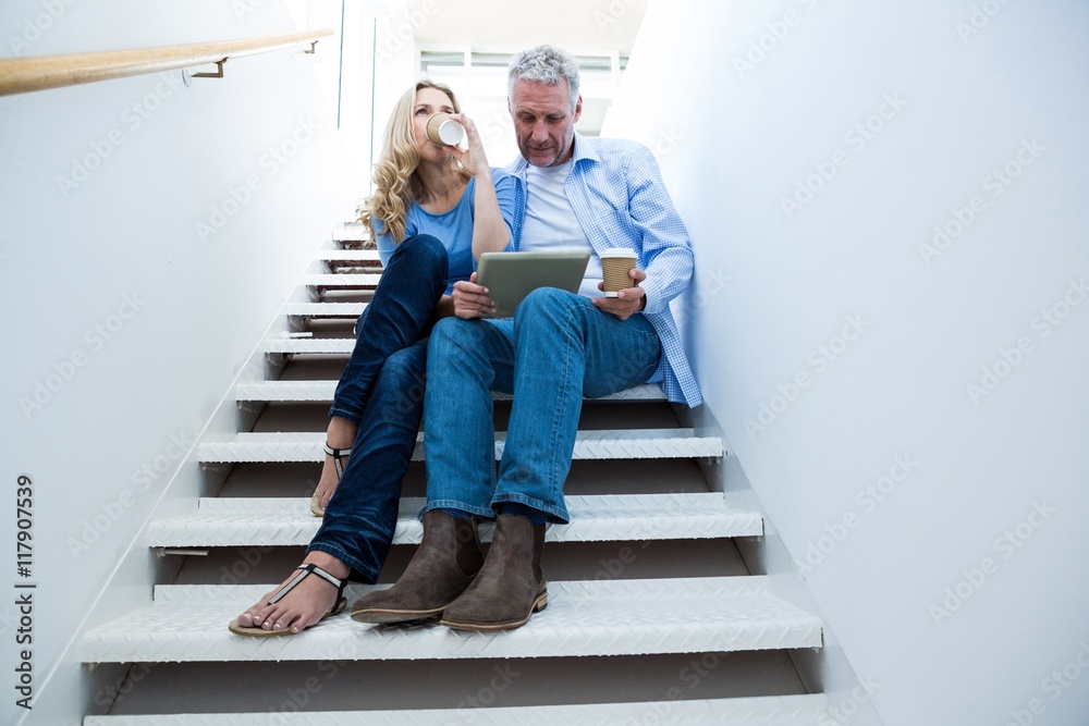 Man with woman holding digital tablet Man with woman holding digital tablet