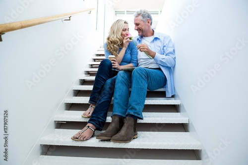 Happy man giving flower to woman photo