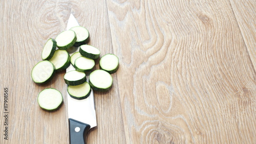 Sliced zucchini lying on a wooden table