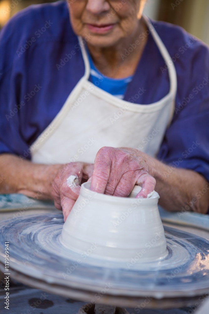 Close-up of female potter making pot Close-up of female potter making pot