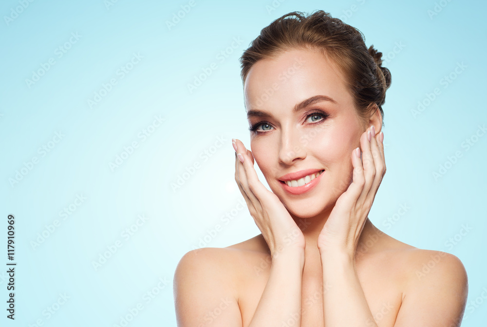 beautiful young woman touching her face