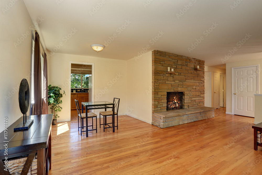 Fototapeta premium Nice living room in blue and brown colors with stone tile fireplace.