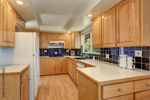 Kitchen room interior with cabinets and tile back splash trim