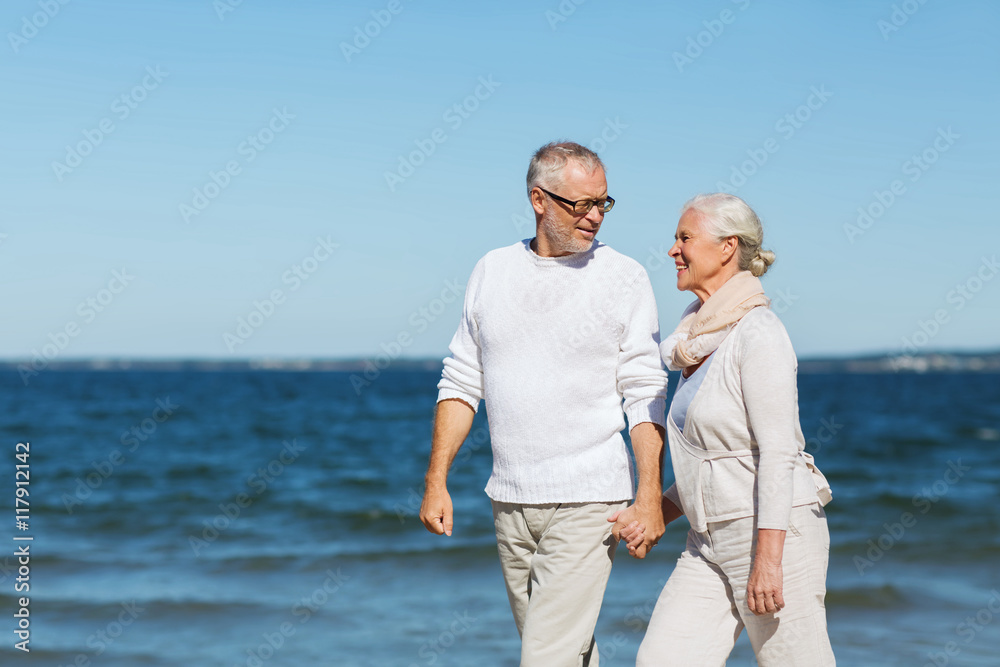 happy senior couple holding hands on summer beach happy senior couple holding hands on summer beach