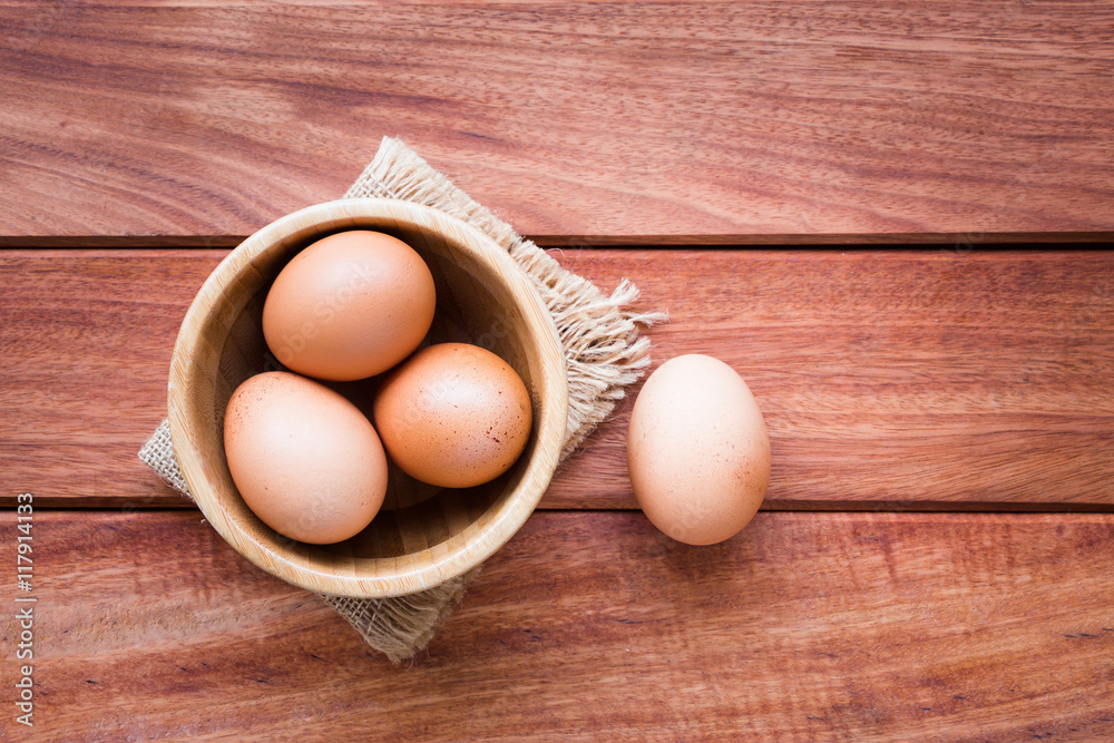 Eggs in bowl on rustic wooden background Eggs in bowl on rustic wooden background