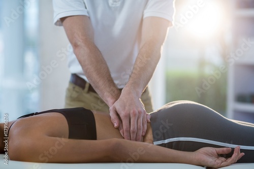 Schilderij op canvas Male physiotherapist giving back massage to female patient