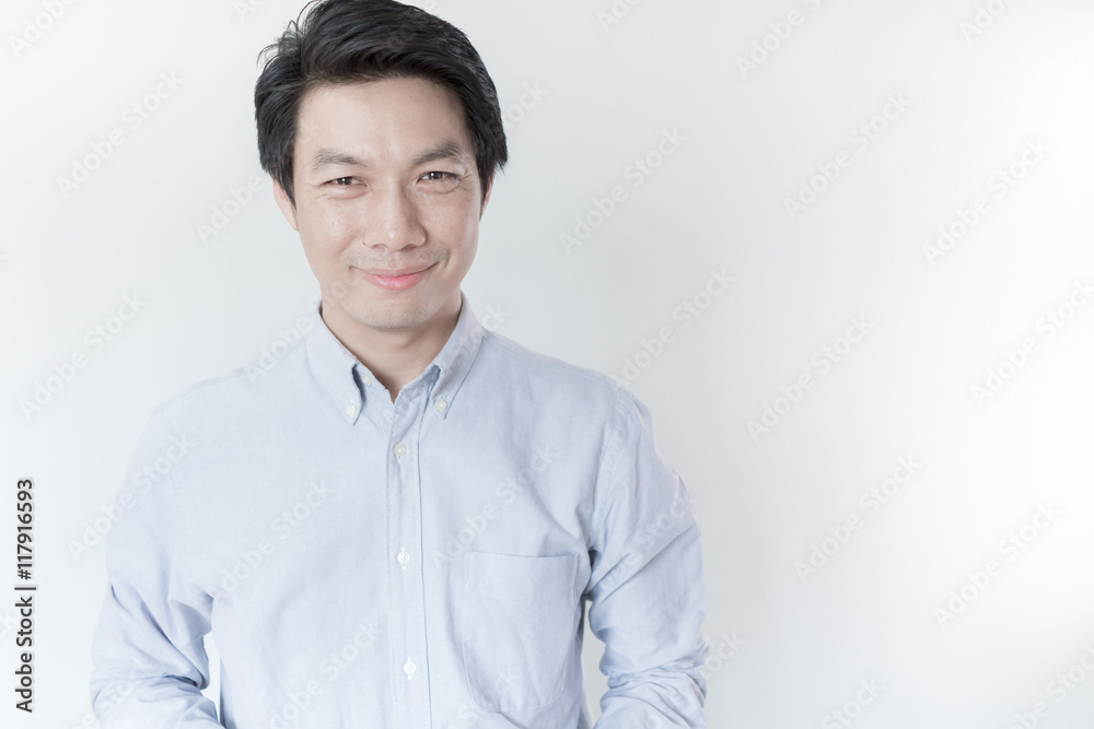 Young Asian man smiling on white background Young Asian man smiling on white background