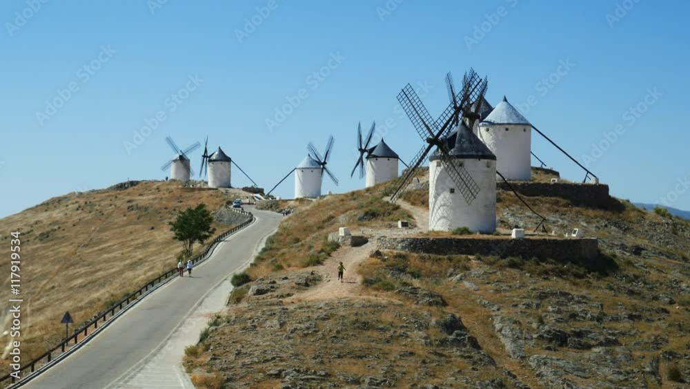 Consuegra, Spain - June 2016: Tourists next to a windmills of Castilla la Mancha, Spain. Windmills at Consuegra