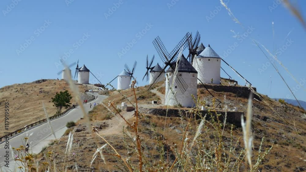 Consuegra, Spain - June 2016: Tourists next to a windmills of Castilla la Mancha, Spain. Windmills at Consuegra