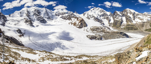 View to Bernina massive and Morteratsch glacier from Diavolezza mountain, canton Graubunden. Diavolezza is one of the ski areas of the Upper Engadin, near Sankt Moritz, Switzerland.  photo