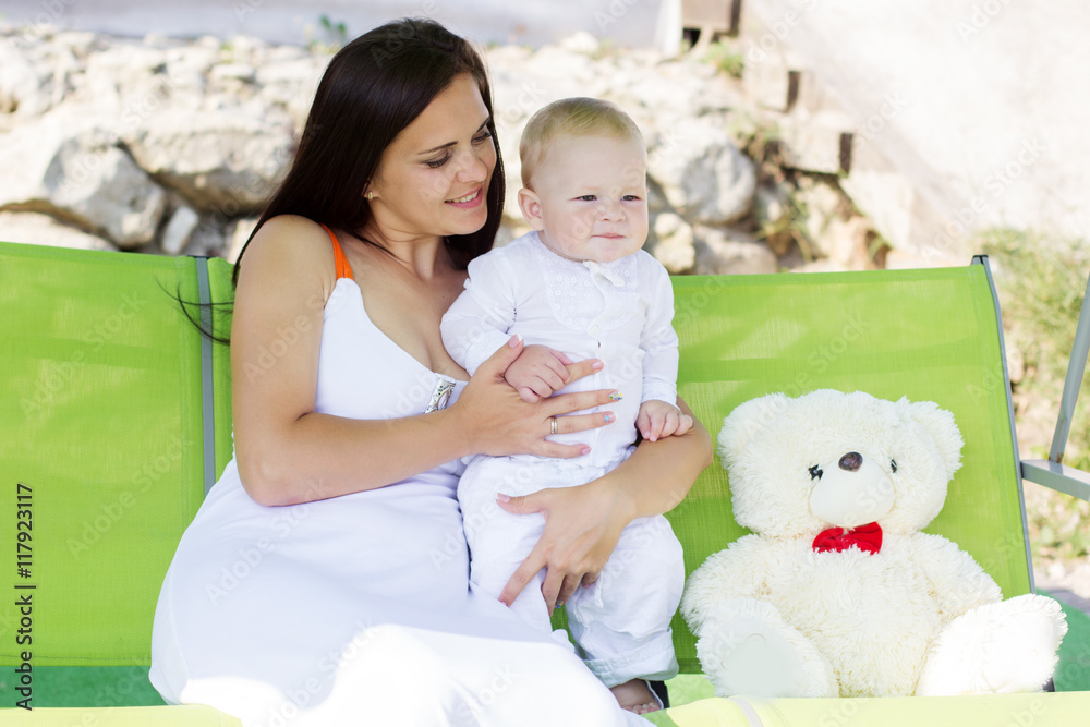 Mother and little baby boy on swing Mother and little baby boy on swing