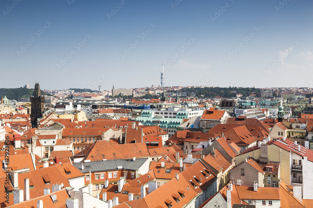Panorama of Prague downtown with red roofs and Charles bridge tower