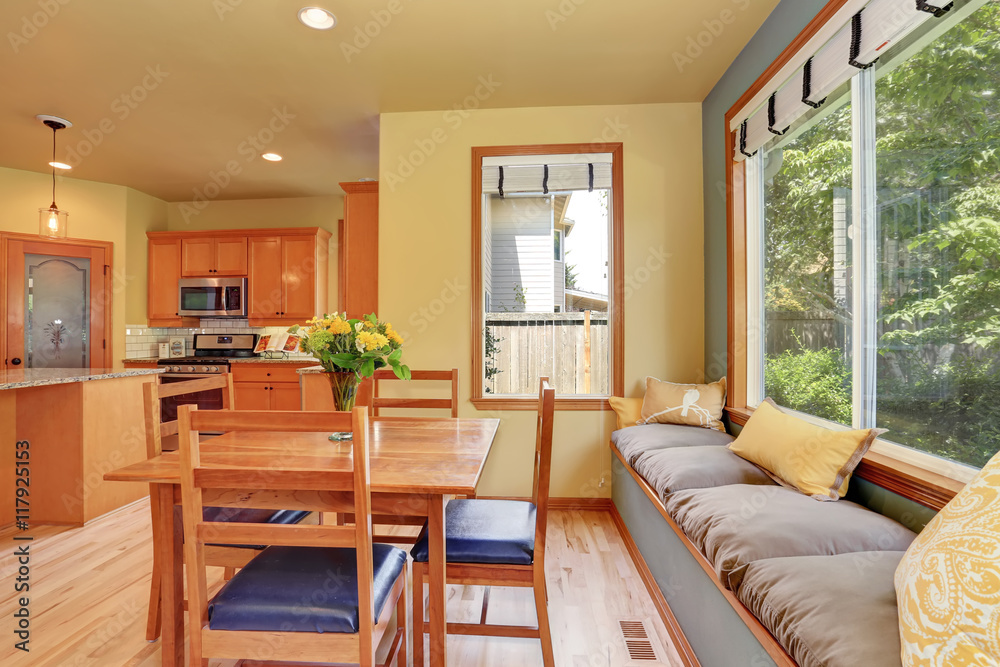 Fototapeta premium Dining area with wooden table set and cozy sitting place.