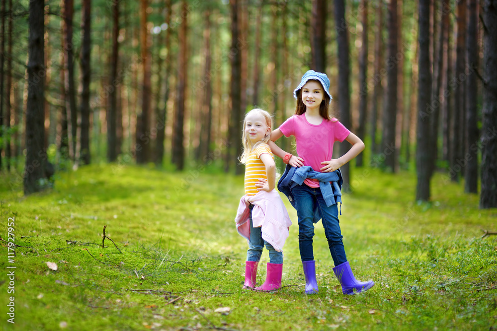 Two adorable little sisters hiking in a forest Two adorable little sisters hiking in a forest