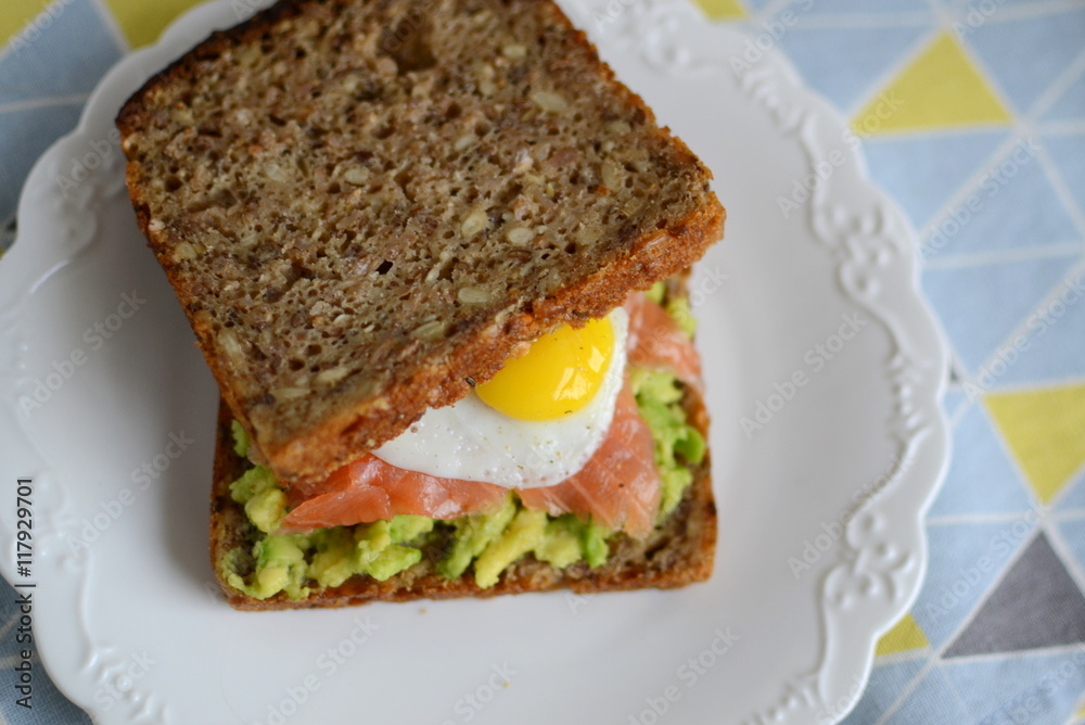 Sandwich with avocado, smoked salmon and quail egg Sandwich with avocado, smoked salmon and quail egg