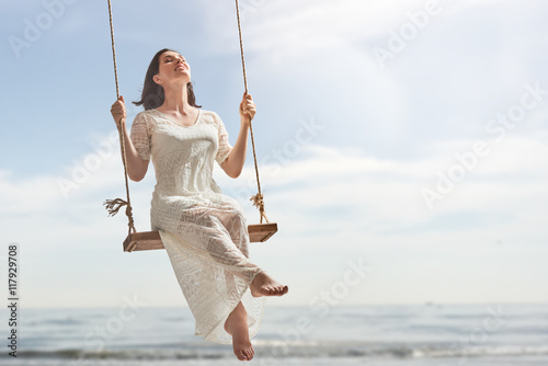 young woman on a swing photo