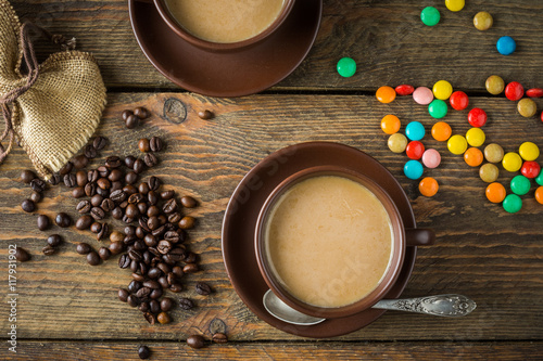 coffee cup, beans and sugar on rustic wooden table background 