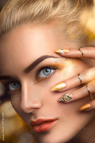 Beauty blonde model sexy girl with perfect golden makeup photo