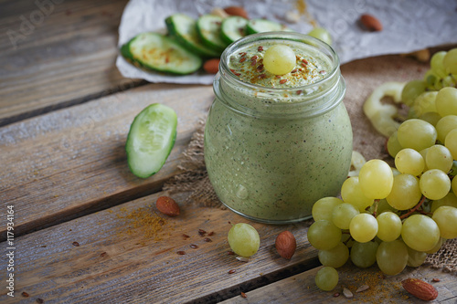 Fresh organic green smoothie with cucumber, parsley, grapes and