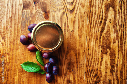 Fresh plum jam on a wooden background