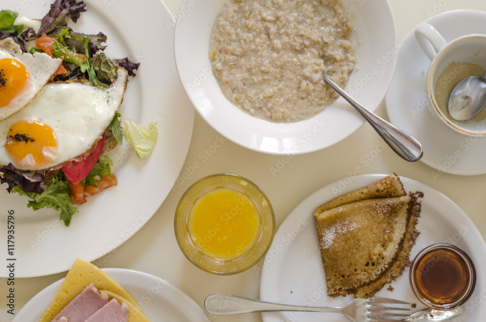 Oatmeal pancakes fresh orange juice coffee and scrambled eggs for breakfast Oatmeal pancakes fresh orange juice coffee and scrambled eggs for breakfast