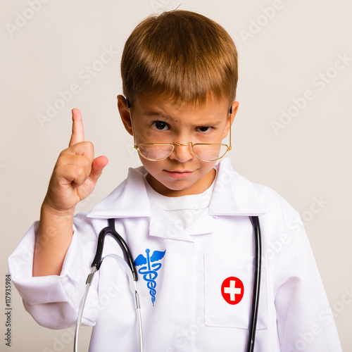 Portrait of a child with glasses and a suit doctor