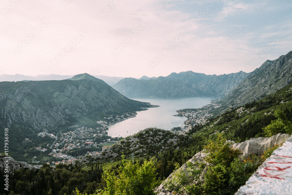 Bay of Kotor with bird eye view. Aerial video Tivat, Muo, Perast, Prcanj, and all the in Montenegro. Sunset in the Montenegrin mountains. from Mount Lovcen. The girl on the bench Bay of Kotor with bird eye view. Aerial video Tivat, Muo, Perast, Prcanj, and all the in Montenegro. Sunset in the Montenegrin mountains. from Mount Lovcen. The girl on the bench