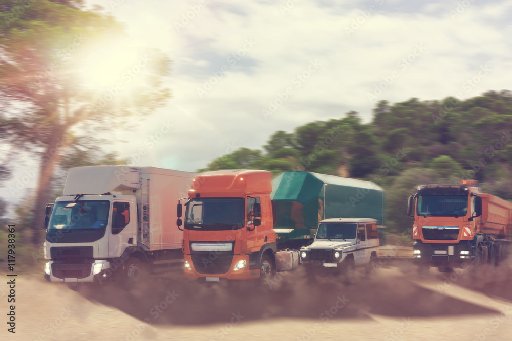 Fototapeta premium Convoy of trucks and a 4x4 on the road