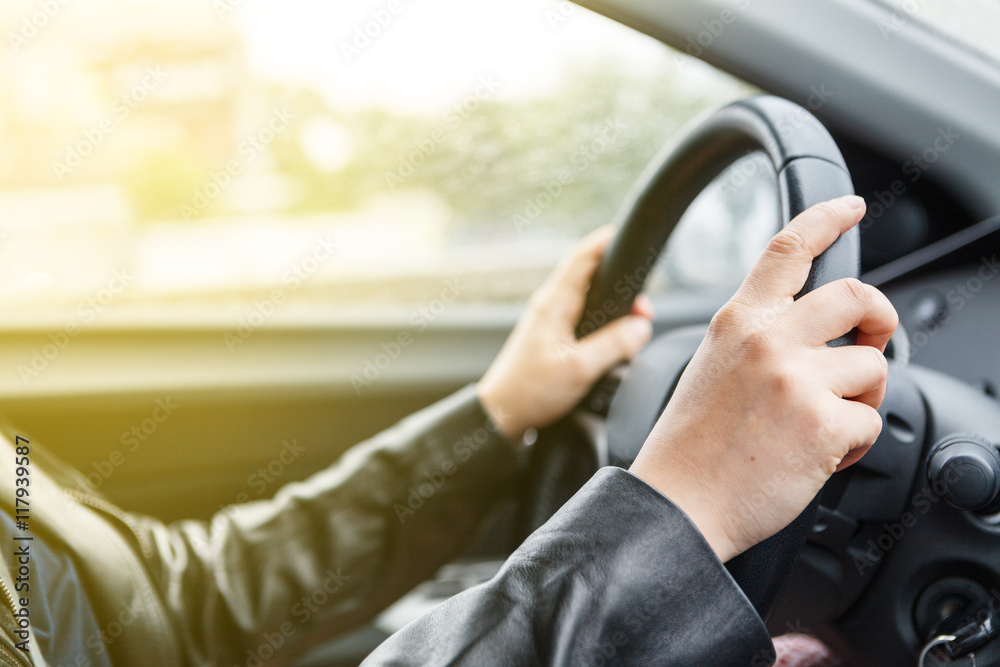Driving a car, hands on steering wheel Driving a car, hands on steering wheel