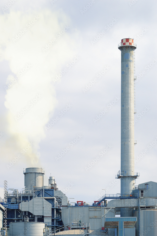 Two chimneys in a factory emitting smoke damaging the environment. Empty copy space for editor's text.