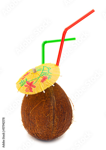 Coconut with straws and umbrella on a white background