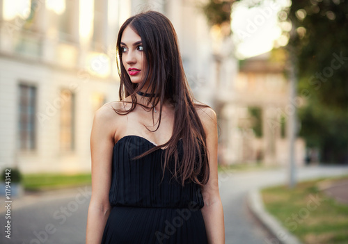 Summer outdoor porttrait of young pretty elegant girl posing at