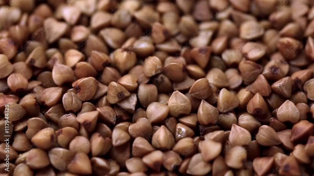 Rotating raw buckwheat. Spinning closeup dry uncooked seeds. 1280x720. Slow Motion Rotating raw buckwheat. Spinning closeup dry uncooked seeds. 1280x720. Slow Motion