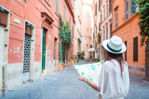 Photography Happy young woman with a city map on desert street in Europe